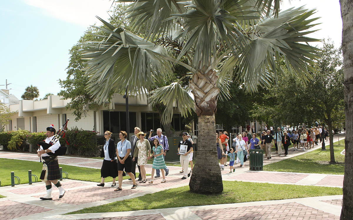 Celestis guests walk behind a bagpiper