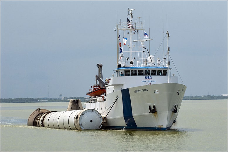 A NASA ship towing a spent space shuttle booster