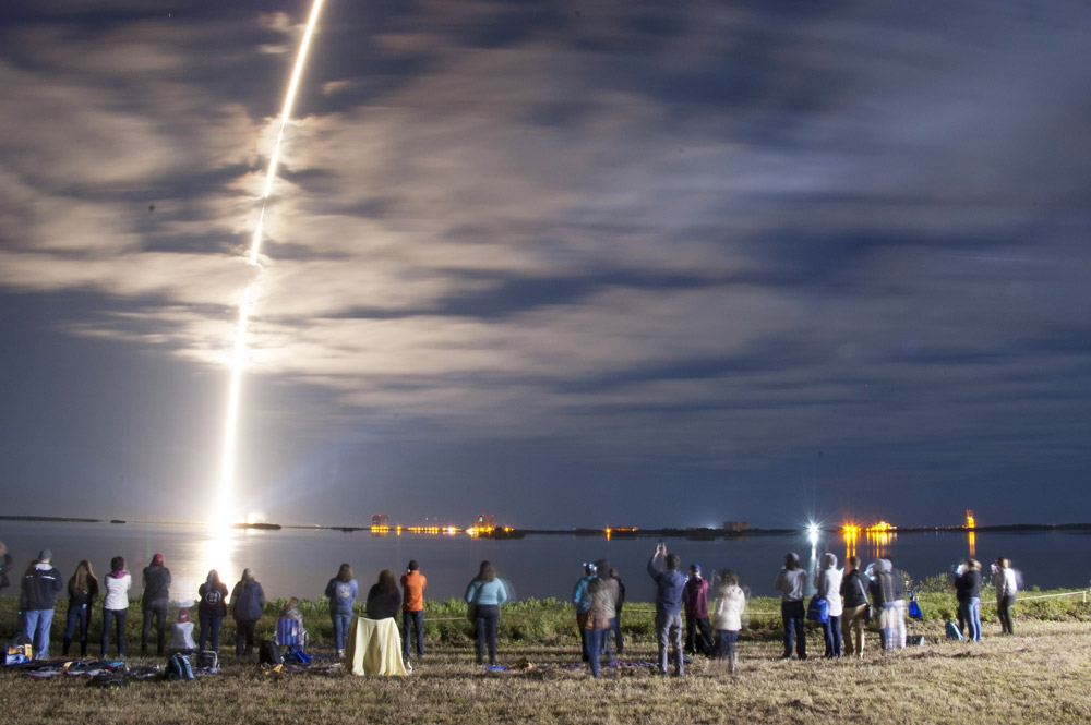 people watching a rocket launch