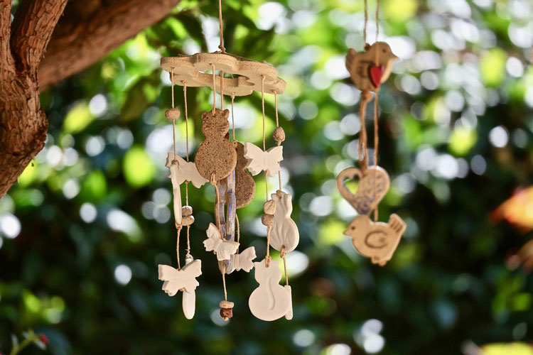 wooden wind chimes with carved birds and cats