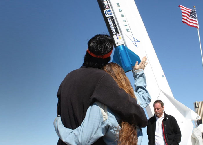 couple waving farewell to participants on a memorial spaceflight