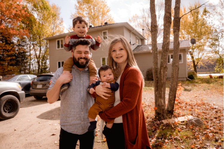 photo of a family outside of a new house