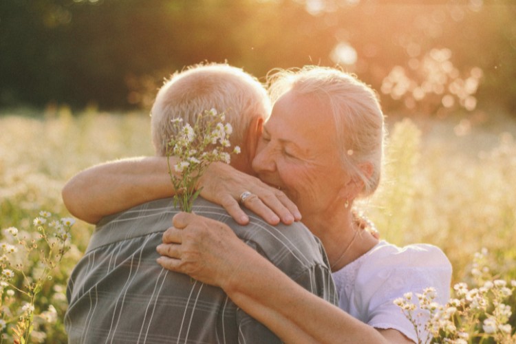 elderly couple hugging