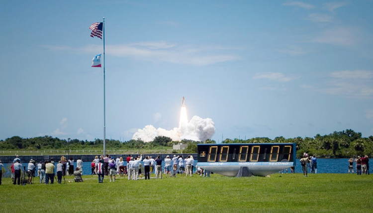 people watching a space rocket launch