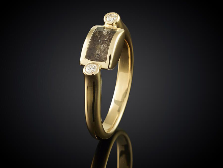 golden ring with ashes isolated on black