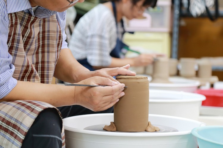 two woman doing pottery together