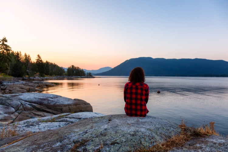 woman watching a peaceful sunrise