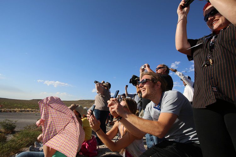 people watching a rocket launch to space