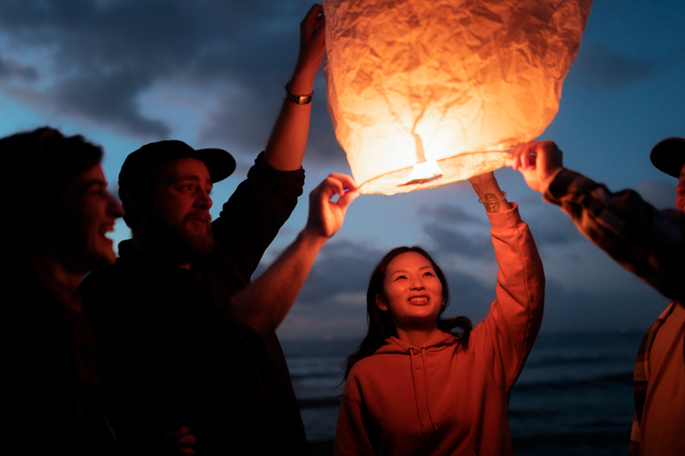 friends lantern release by seaside