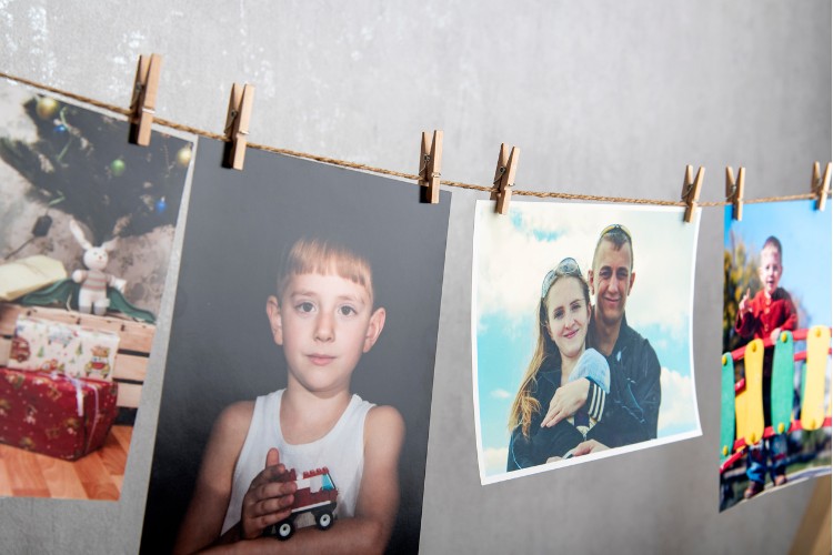 man photos hang with clothespins on rope
