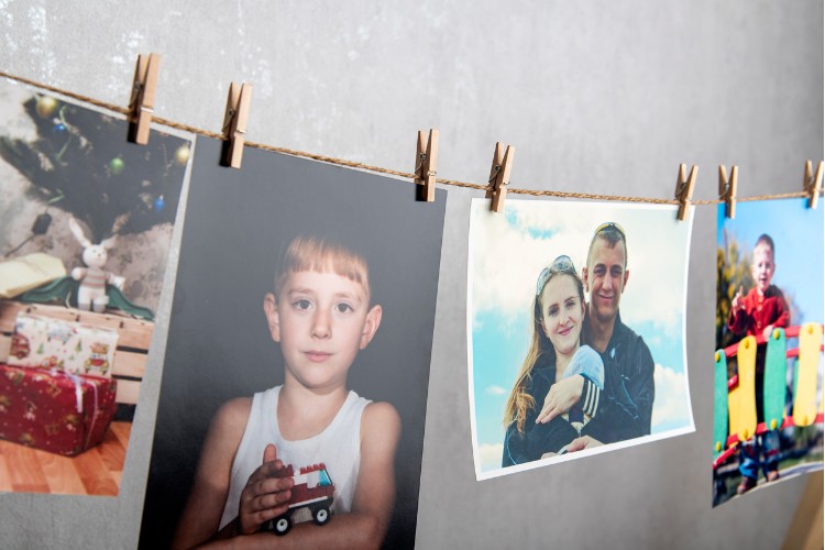 man photos hang with clothespins on rope