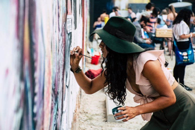 woman painting on the wall