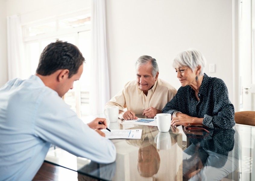 elderly couple signing a cremation memorial services contract.jpg