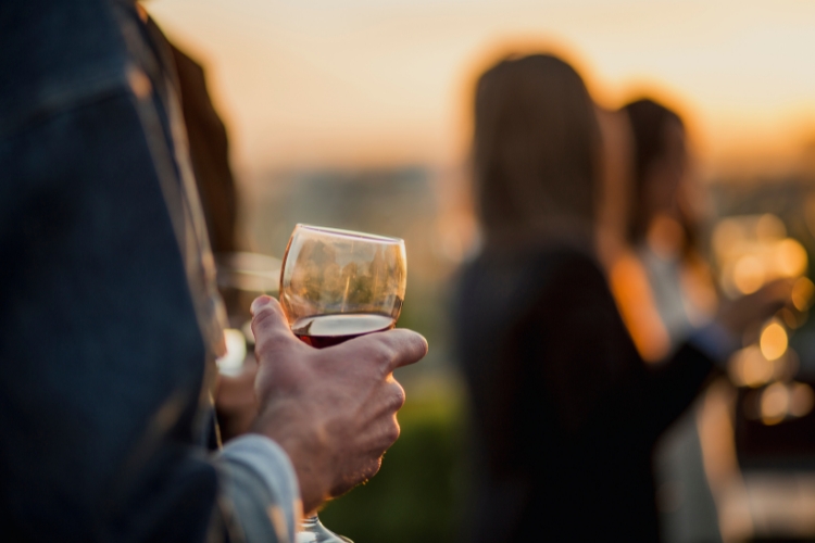 close up hand holding wine