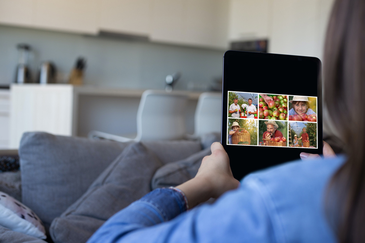 woman browsing a digital memorial of images on a tablet