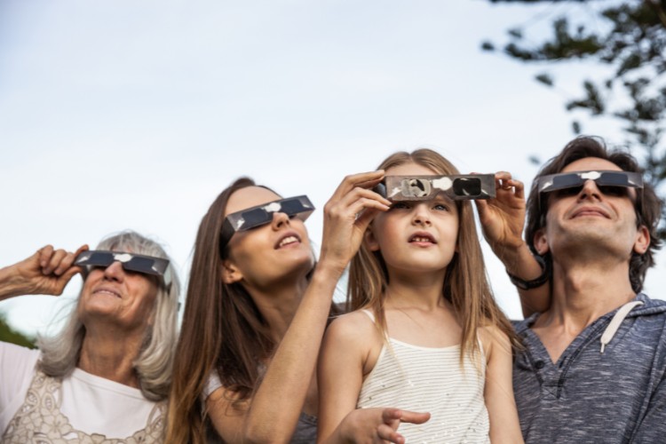 family watching total solar eclipse