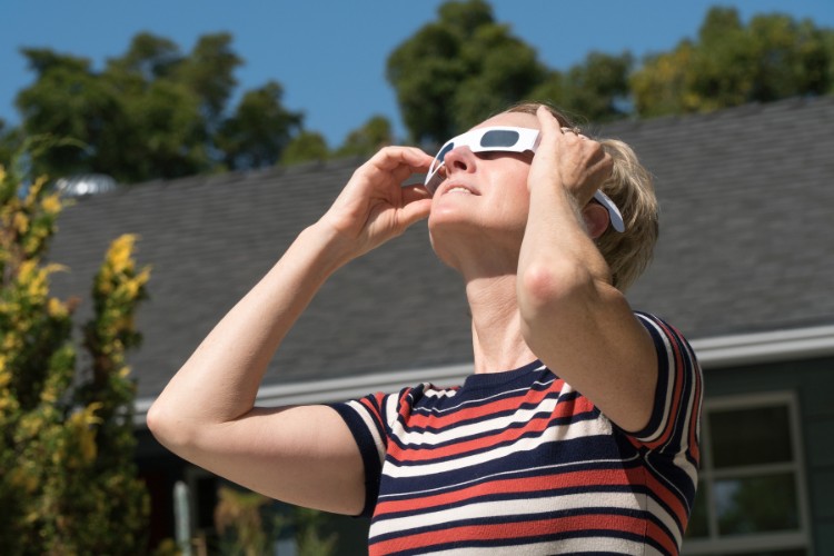 woman wearing eclipse protection glasses