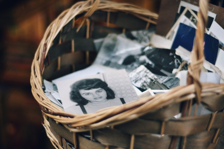 Basket filled with vintage photographs for memorial service display