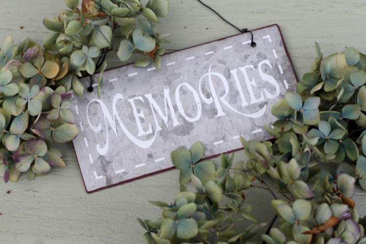 Memorial table decorated with ‘Memories’ sign and plants