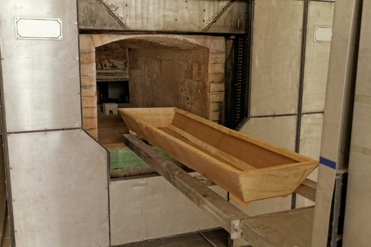 Beginning of the cremation process with wooden coffin in chamber