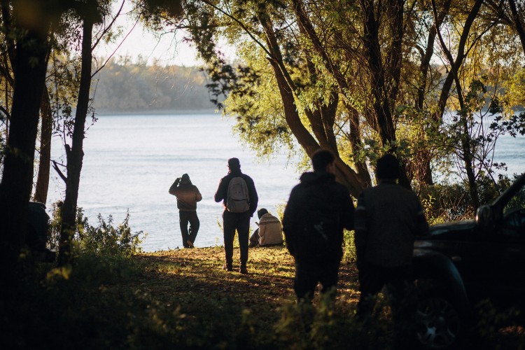 Family gathering for a lakeside ash scattering memorial