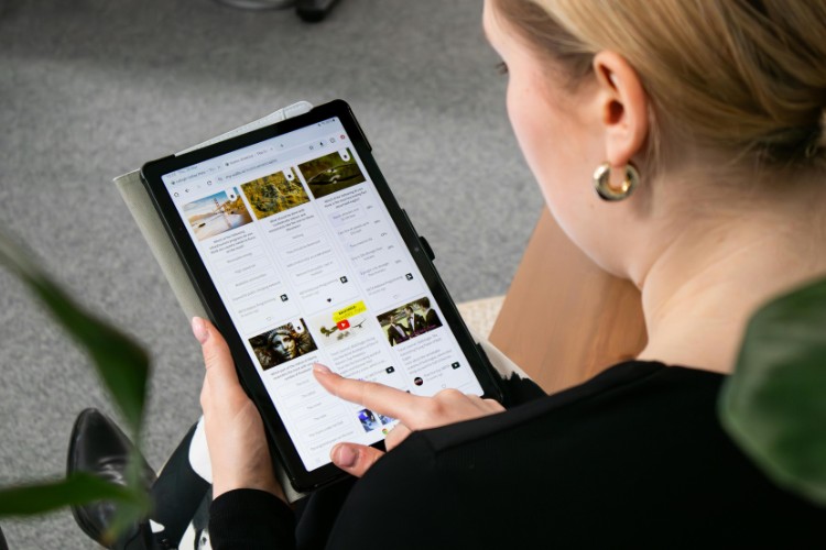 Attendee reviewing details of a celebration of life gathering announcement on screen