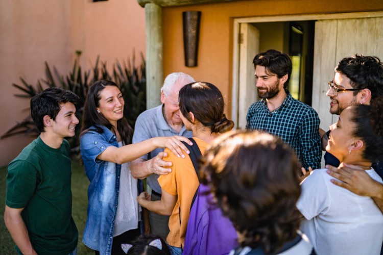 Friends arriving and meeting family at a casual celebration of life gathering