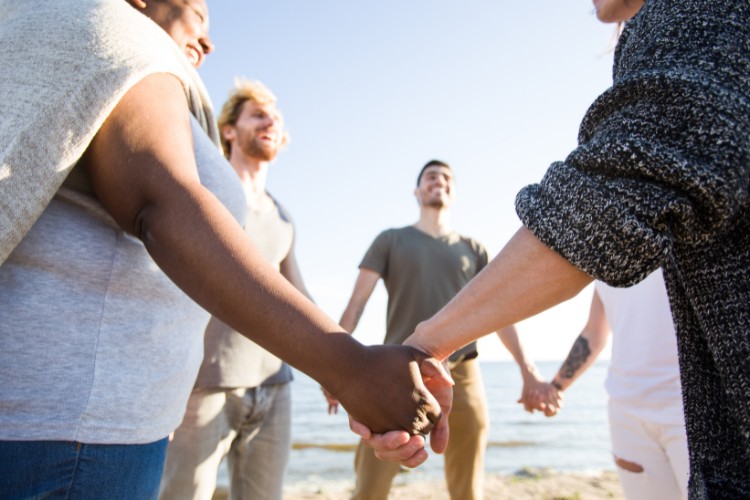 Friends gathered by the sea for a celebration of life ceremony