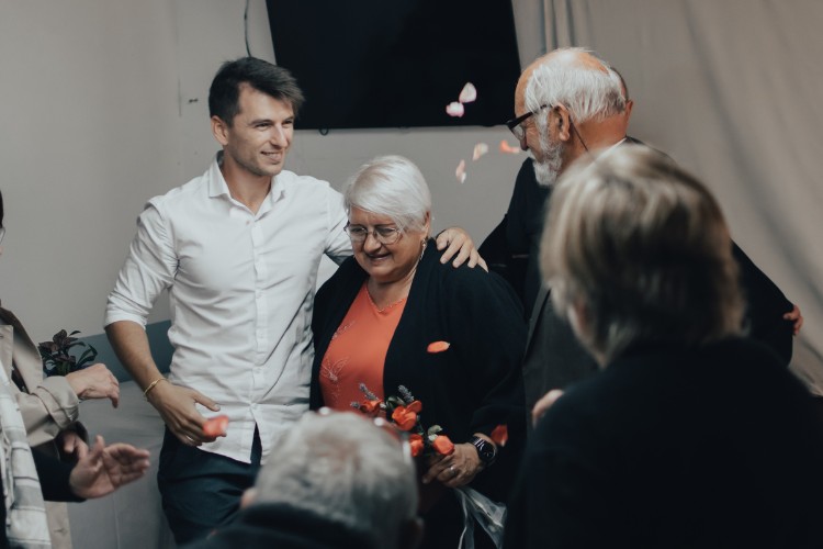 Family embracing and sharing memories during an indoor celebration of life