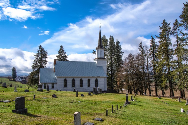 White chapel with cemetery grounds as a venue for a celebration of life