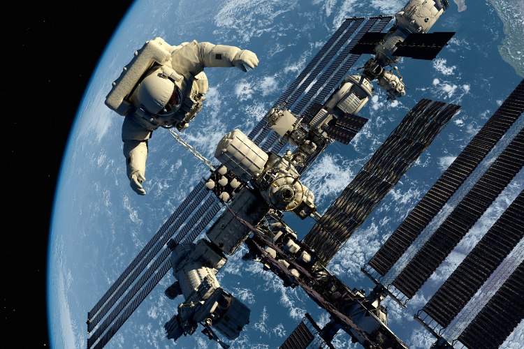 Astronaut and space station in outer space