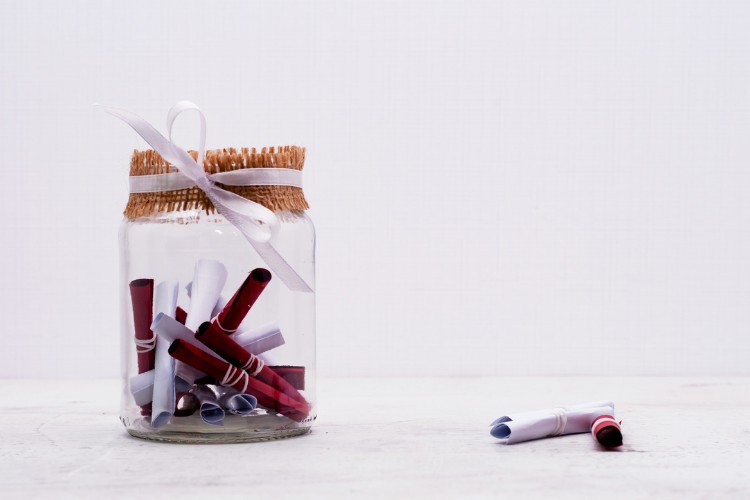 Memory jar filled with rolled notes written in tribute to a beloved grandparent