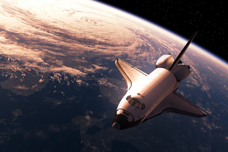 Space shuttle orbiting Earth carrying space travelers